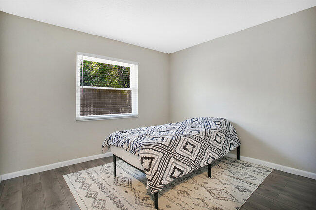 2879 Lancaster Road Melbourne, FL 32935 - Photo 16 of 28 a bedroom with a bed and a window