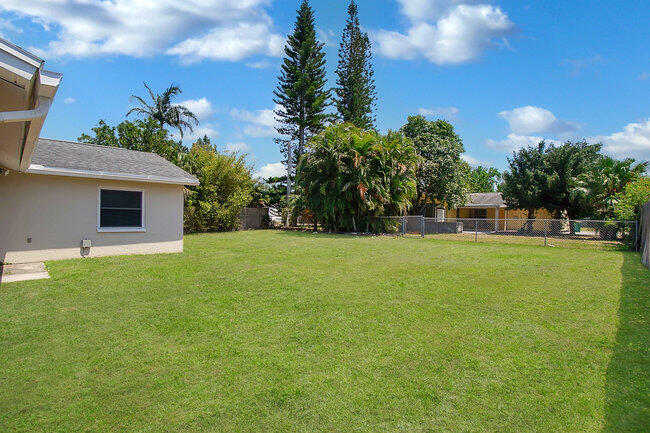 2879 Lancaster Road Melbourne, FL 32935 - Photo 18 of 28 a view of a house with backyard and a tree