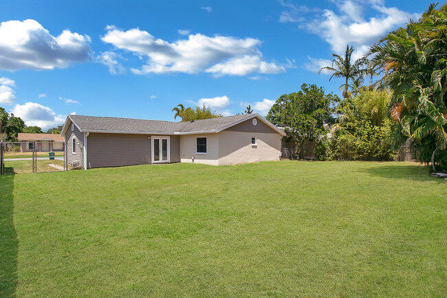 2879 Lancaster Road Melbourne, FL 32935 - Photo 19 of 28 a front view of house with yard and trees