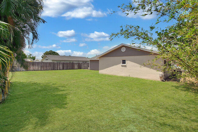 2879 Lancaster Road Melbourne, FL 32935 - Photo 20 of 28 a front view of a house with a yard