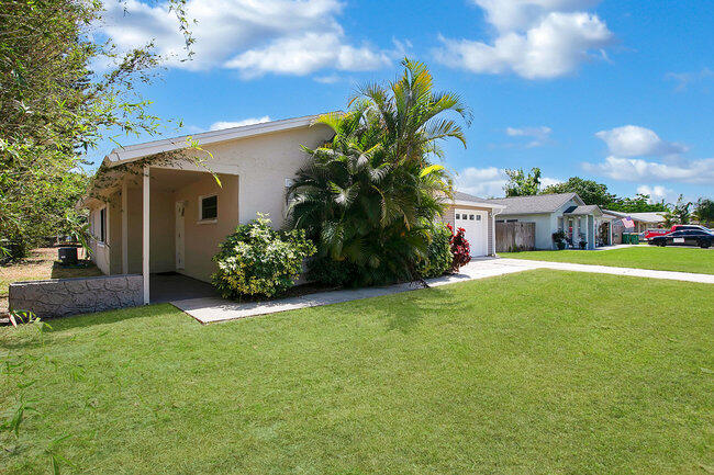 2879 Lancaster Road Melbourne, FL 32935 - Photo 2 of 28 a view of a house with backyard and garden