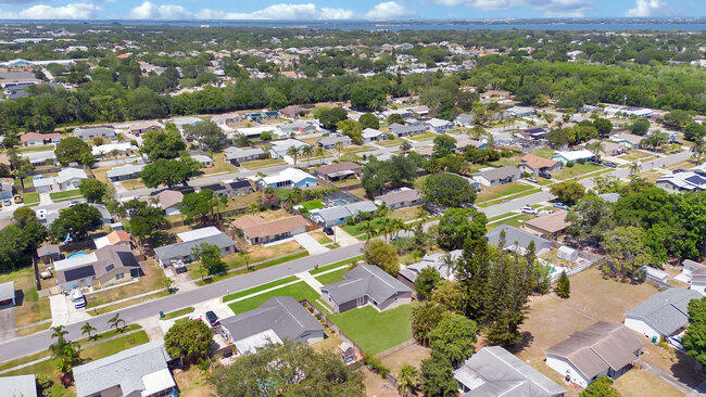 2879 Lancaster Road Melbourne, FL 32935 - Photo 24 of 28 an aerial view of residential houses with outdoor space and trees