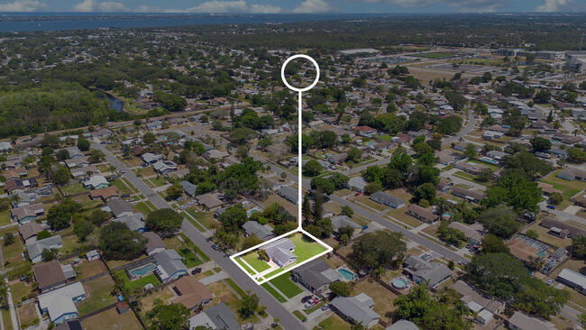 2879 Lancaster Road Melbourne, FL 32935 - Photo 28 of 28 an aerial view of a house with a yard