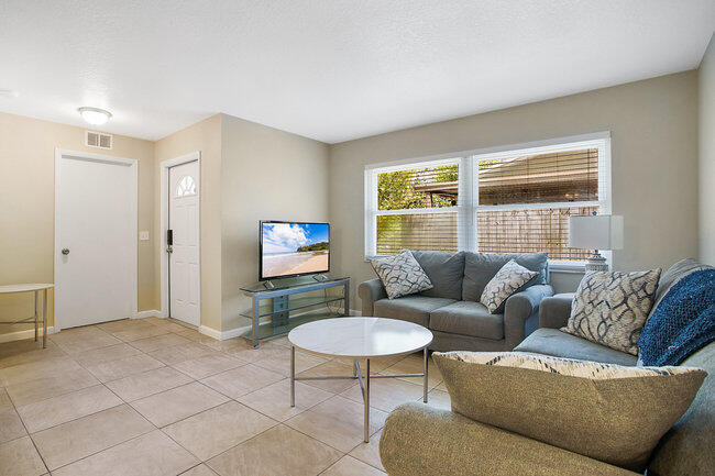 2879 Lancaster Road Melbourne, FL 32935 - Photo 9 of 28 a living room with furniture and a window
