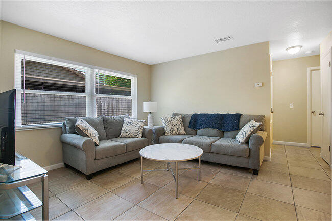 2879 Lancaster Road Melbourne, FL 32935 - Photo 10 of 28 a living room with furniture and a window