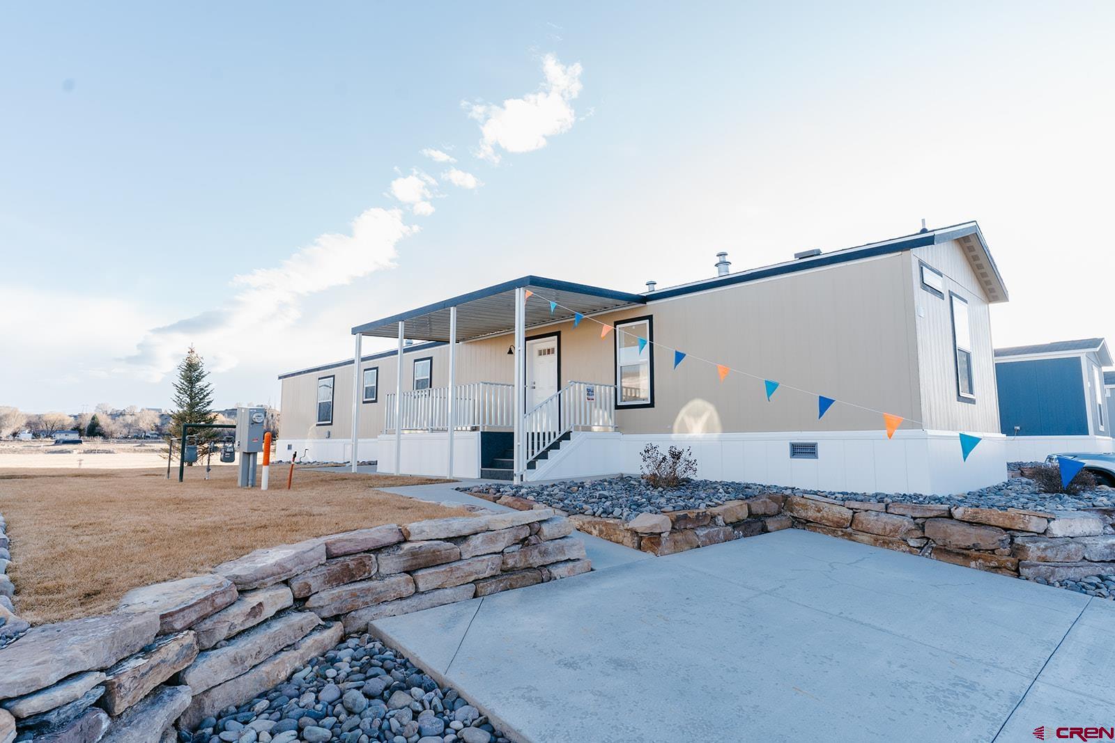 62650 Lasalle Road, Unit 330 Montrose, CO 81403 - Photo 1 of 23 a backyard of a house with table and chairs