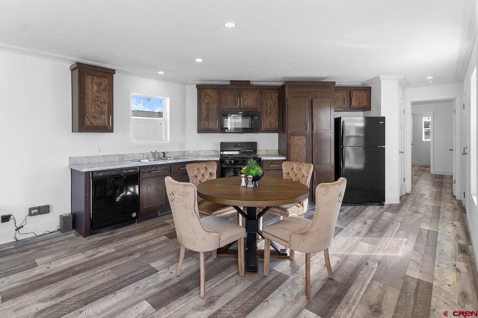62650 Lasalle Road, Unit 330 Montrose, CO 81403 - Photo 11 of 23 a view of a dining room with furniture and wooden floor