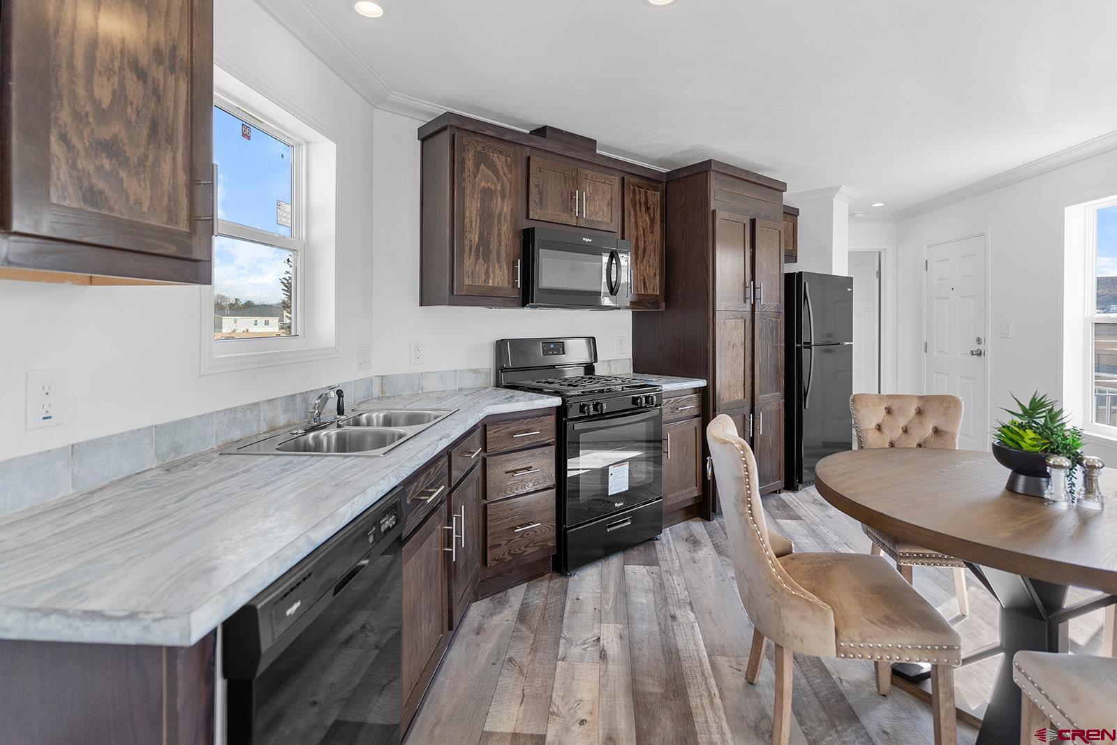 62650 Lasalle Road, Unit 330 Montrose, CO 81403 - Photo 12 of 23 a kitchen with stainless steel appliances granite countertop a kitchen island hardwood floor sink stove and refrigerator