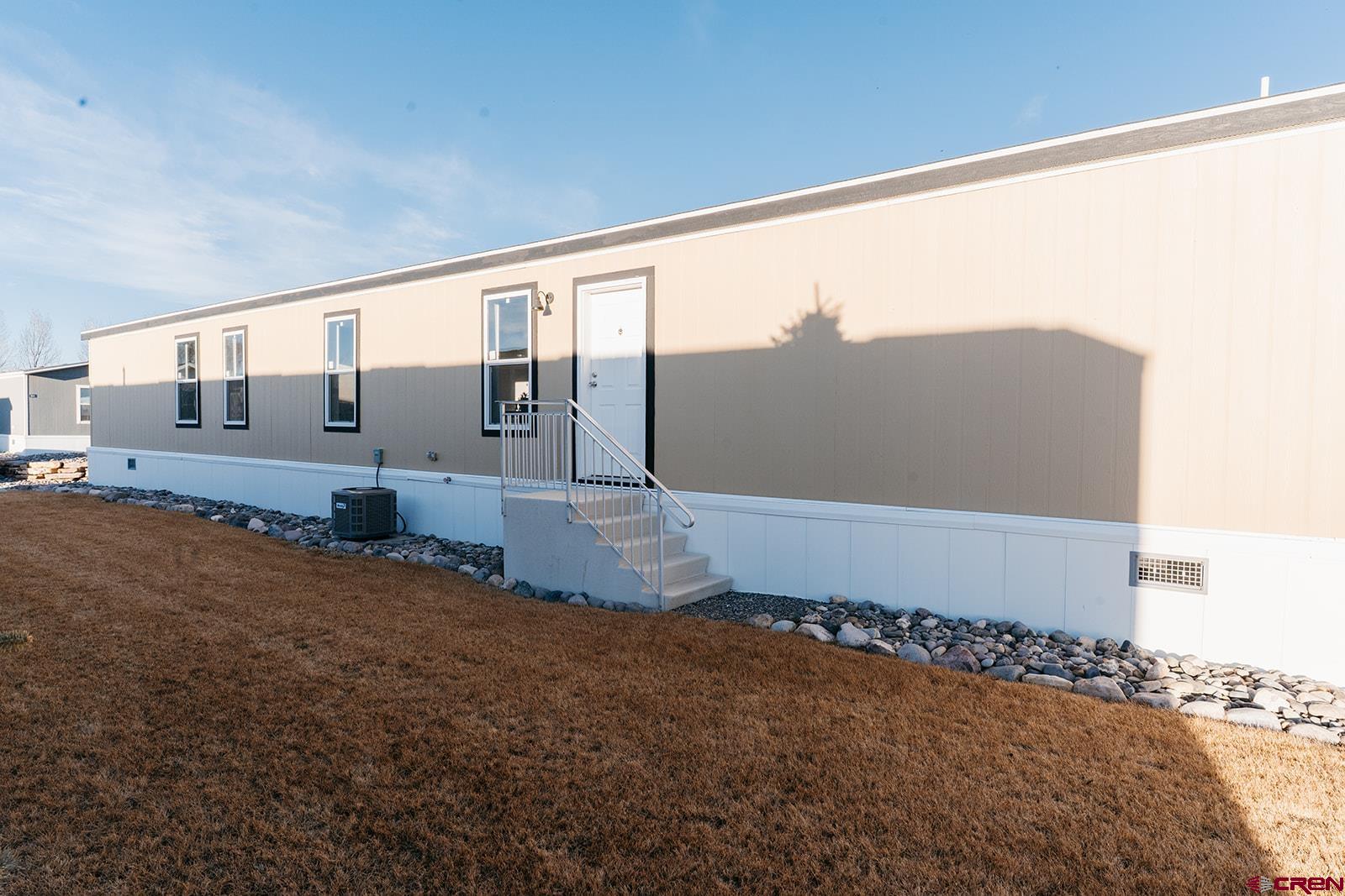 62650 Lasalle Road, Unit 330 Montrose, CO 81403 - Photo 4 of 23 a front view of a house with a yard