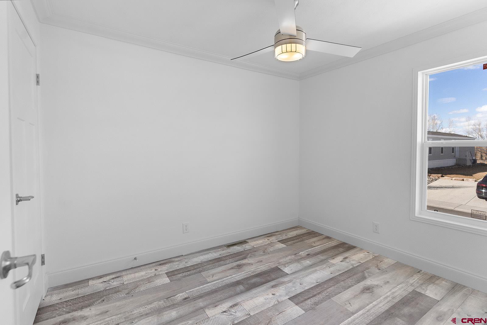 62650 Lasalle Road, Unit 330 Montrose, CO 81403 - Photo 7 of 23 wooden floor in an empty room with a window