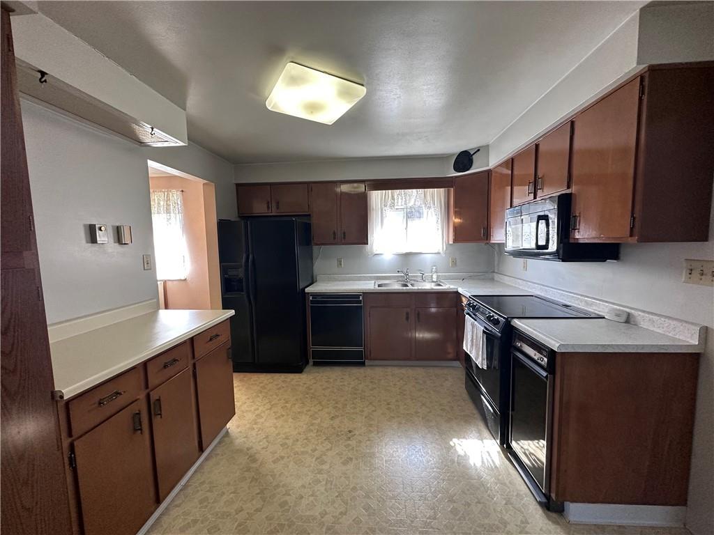 978 Pollock Store Road Slippery Rock, PA 16057 - Photo 2 of 25 a kitchen with stainless steel appliances granite countertop a stove a sink a refrigerator white cabinets and wooden floor