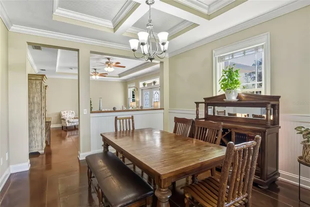 a kitchen with a table chairs refrigerator and cabinets