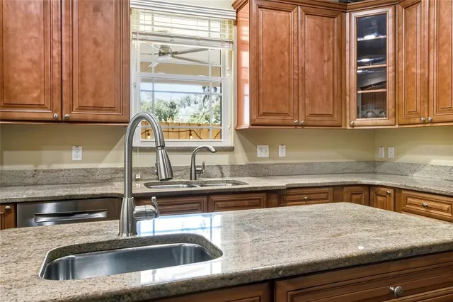 a kitchen with stainless steel appliances a stove a refrigerator and a dining table