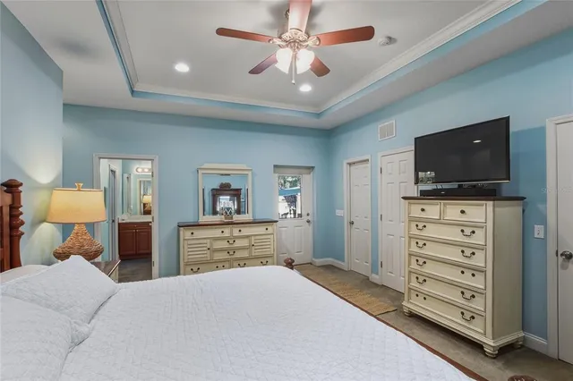 a living room with furniture a chandelier and a large window
