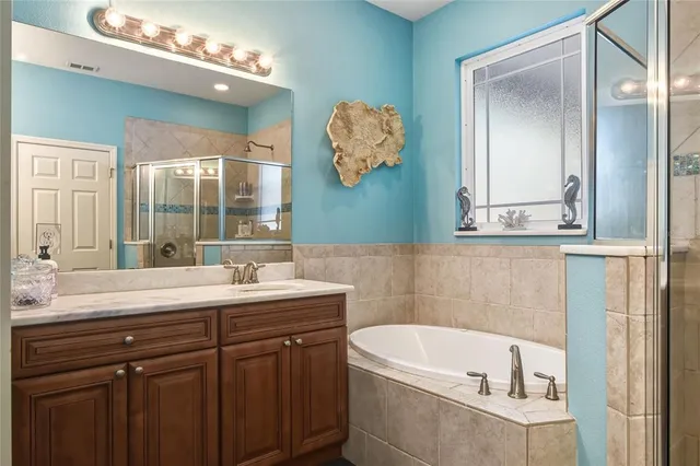 a bathroom with a sink toilet vanity and shower