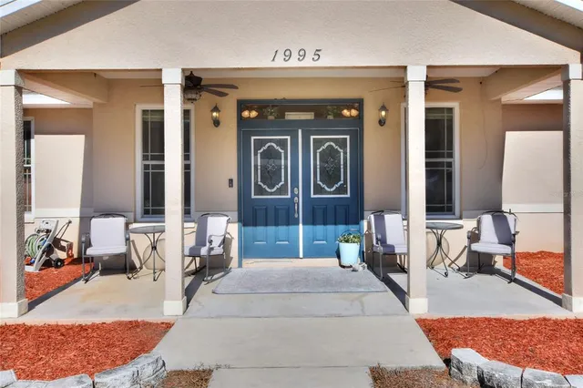 an aerial view of residential building with parking and yard
