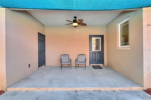 a view of a patio with table and chairs under an umbrella