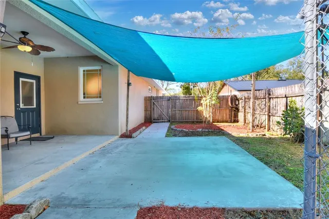 a view of a backyard with wooden fence