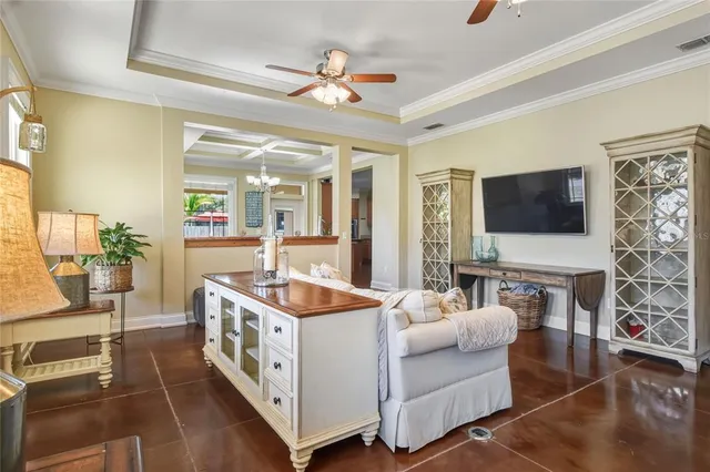a living room with furniture and a chandelier