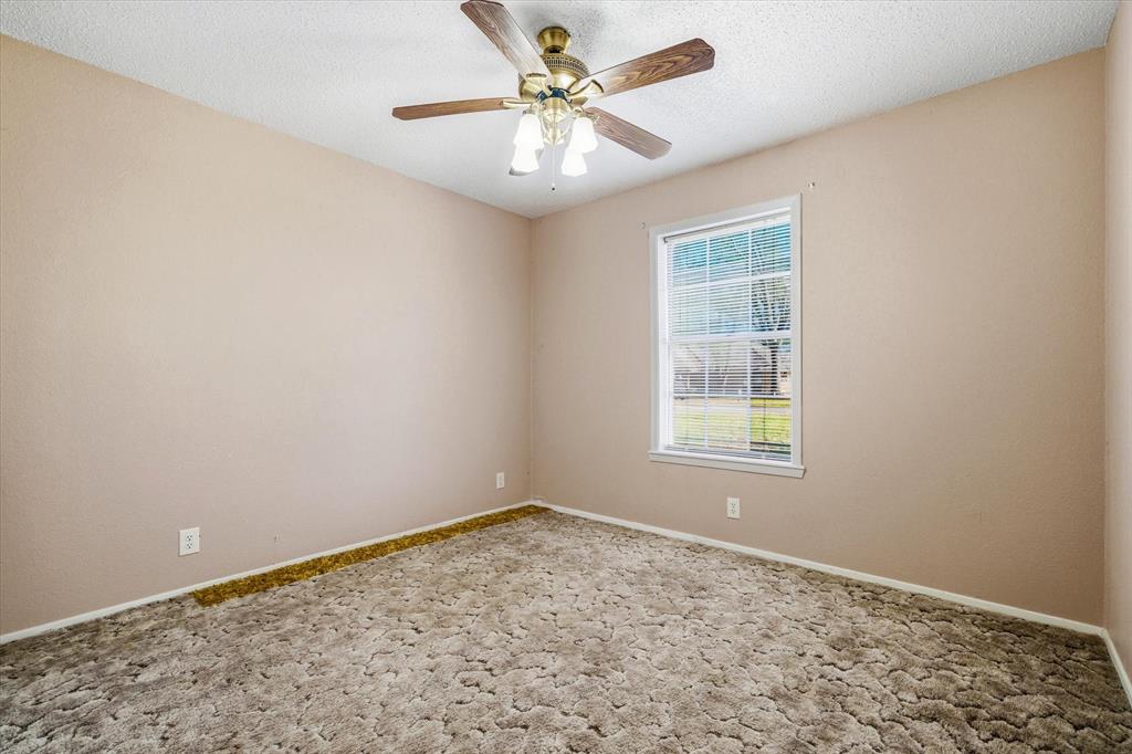 216 Helen Drive Lindale, TX 75771 - Photo 27 of 39 an empty room with windows and fan