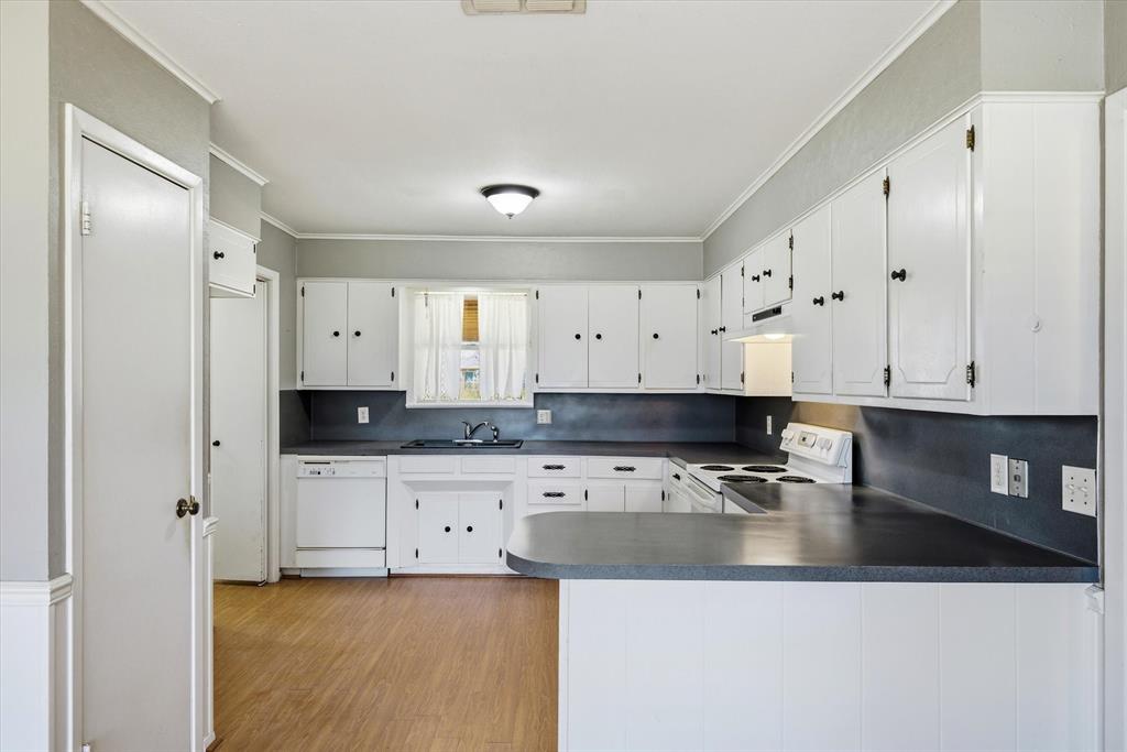 216 Helen Drive Lindale, TX 75771 - Photo 7 of 39 a kitchen with granite countertop a sink a stove and cabinets