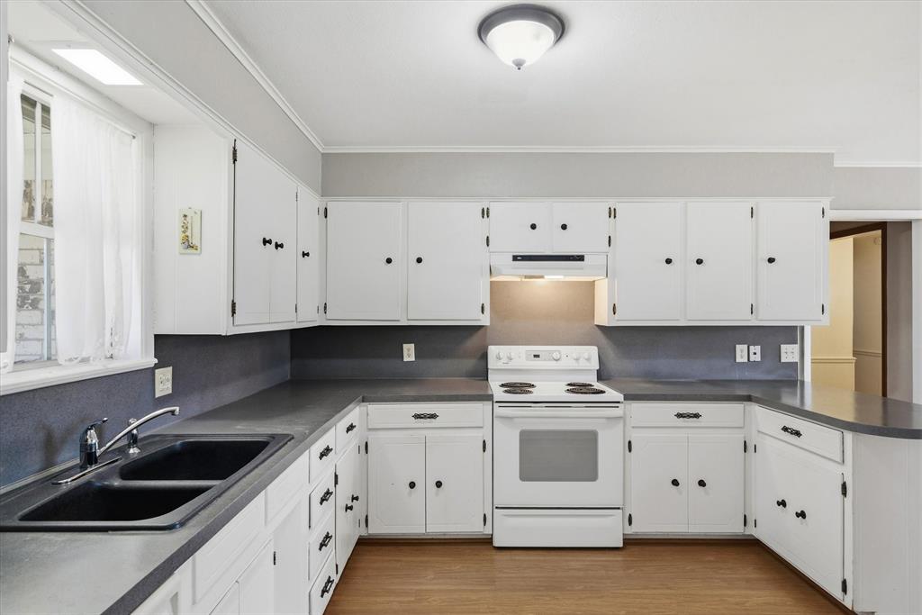 216 Helen Drive Lindale, TX 75771 - Photo 8 of 39 a kitchen with white cabinets and white appliances