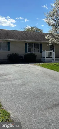 a front view of house with yard and trees