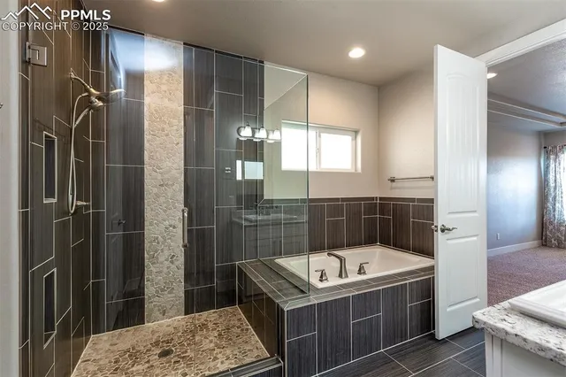 a bathroom with a tub sink and shower