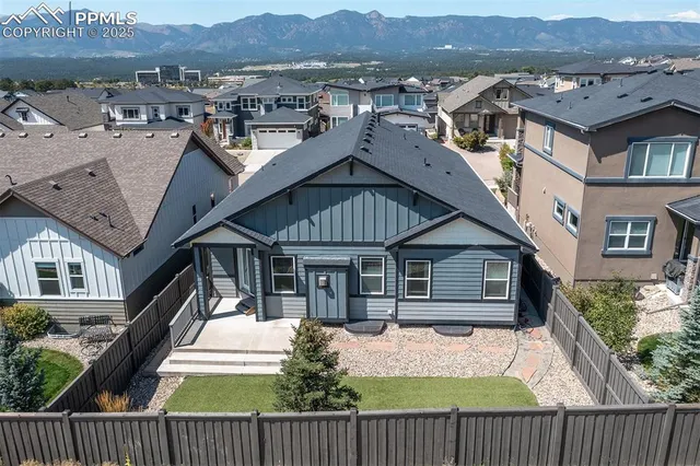 an aerial view of a house with a yard
