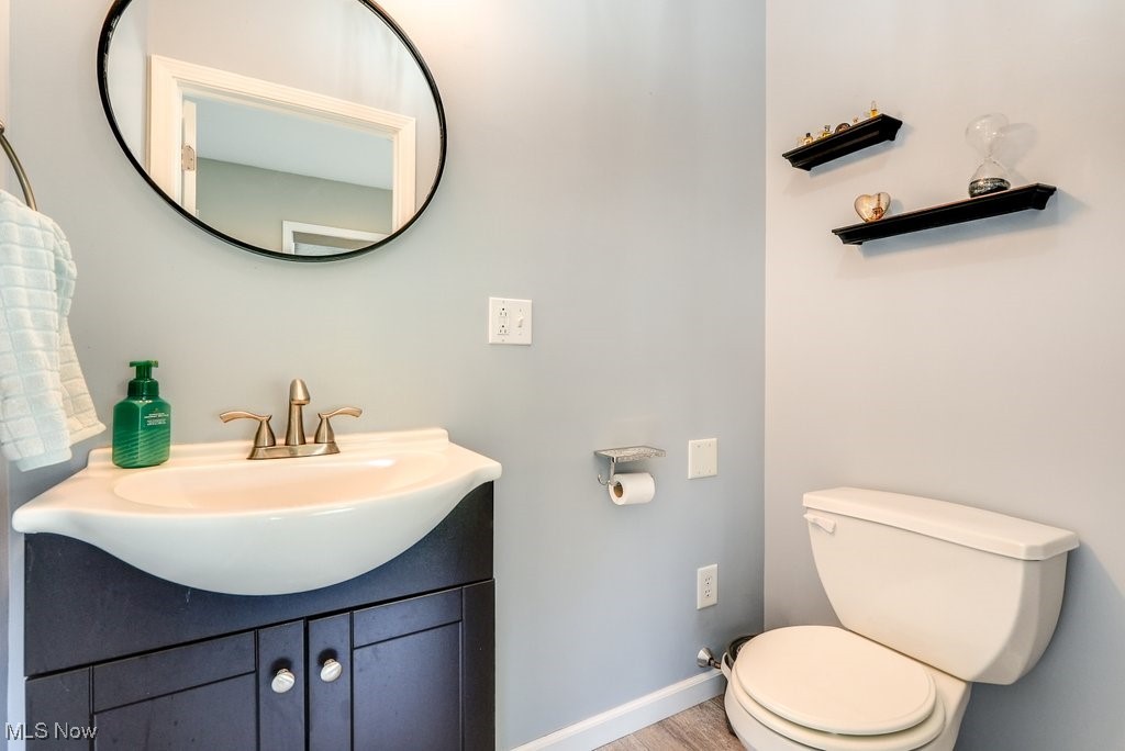 461 New Milford Road Atwater, OH 44201 - Photo 27 of 31 Bathroom with wood-type flooring, vanity, and toilet