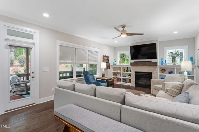 a living room with fireplace furniture and a flat screen tv