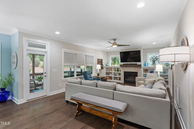 a living room with furniture a fireplace and a flat screen tv