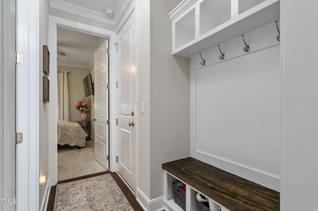 a view of hallway with walk in closet and wooden floor