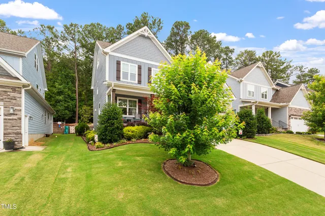a view of a house with swimming pool and a yard