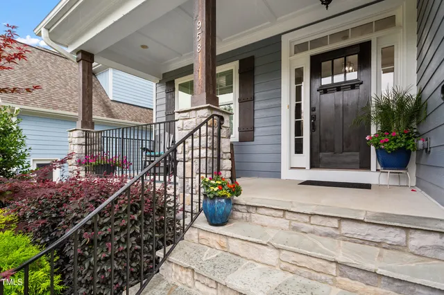 a view of a house with potted plants