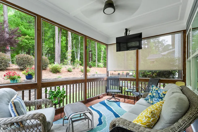 a living room with furniture and a floor to ceiling window