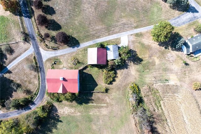 an aerial view of a house with a yard and lake view