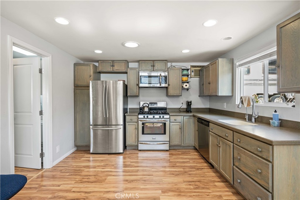 28274 San Martinez Grande Canyon Road Castaic, CA 91384 - Photo 34 of 48 a kitchen with stainless steel appliances granite countertop a refrigerator and a stove top oven