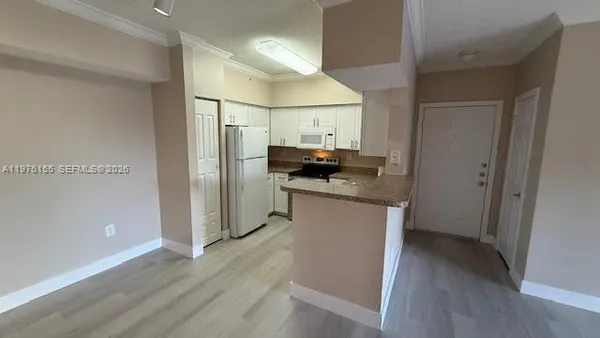 a kitchen with stainless steel appliances granite countertop a refrigerator and a stove