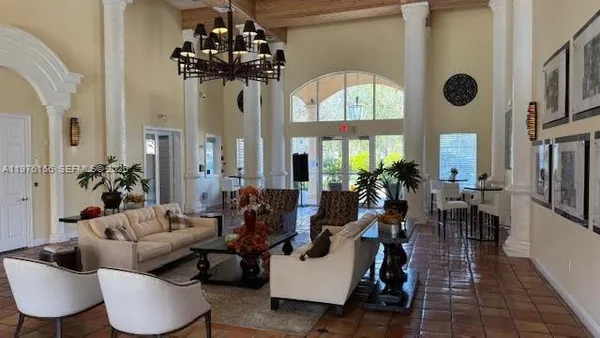 a living room with fireplace furniture and a large window