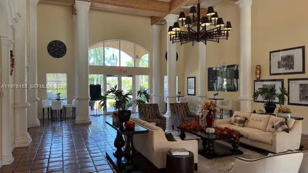 a living room with fireplace furniture and a floor to ceiling window