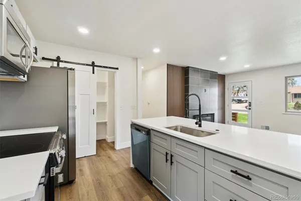 a spacious bathroom with a double vanity sink a mirror and shower