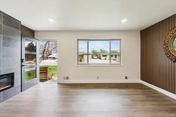 an empty room with wooden floor and a window