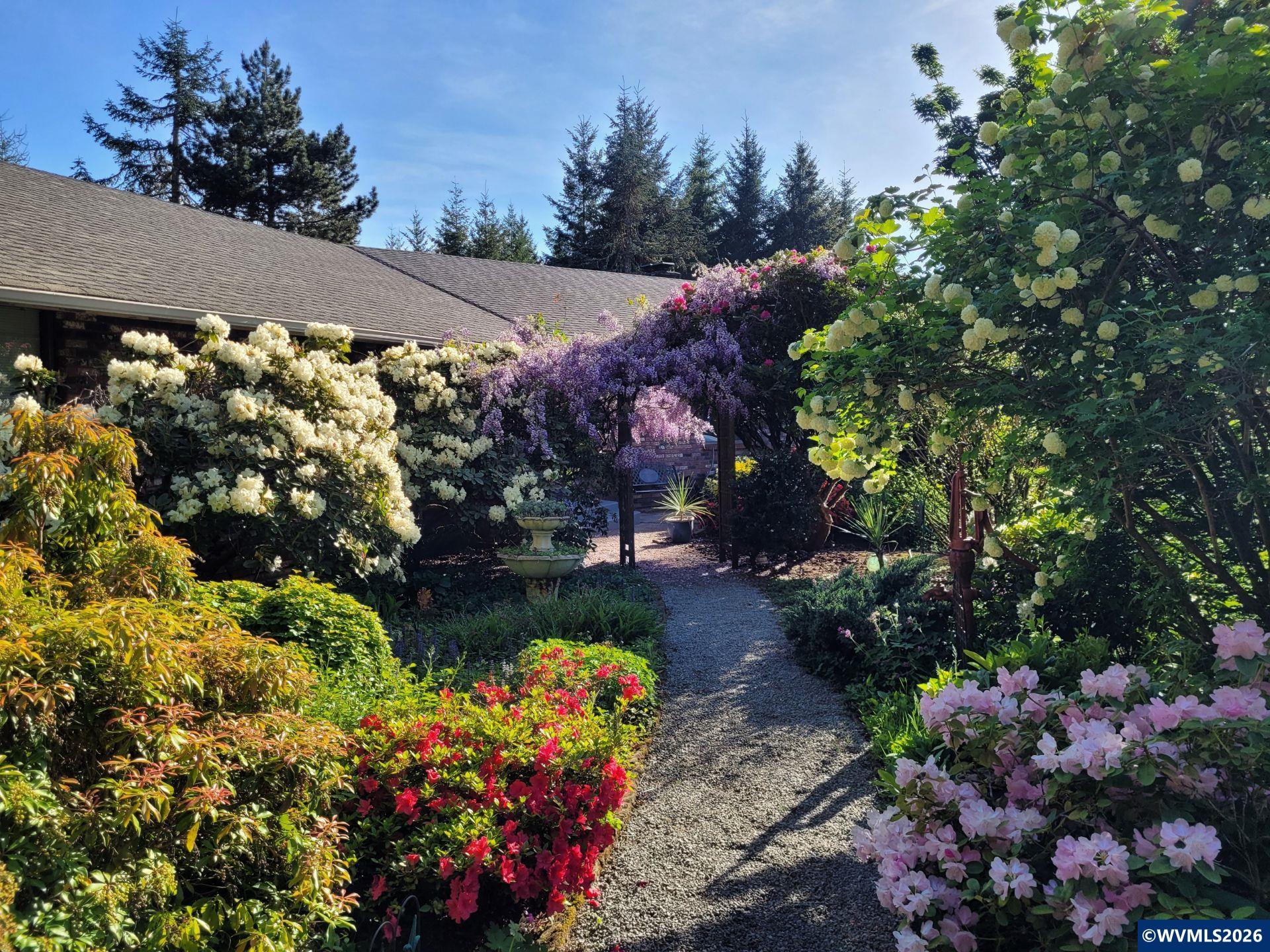 27572 South Kinzy Road Estacada, OR 97023 - Photo 3 of 50 a view of a garden with plants and flowers