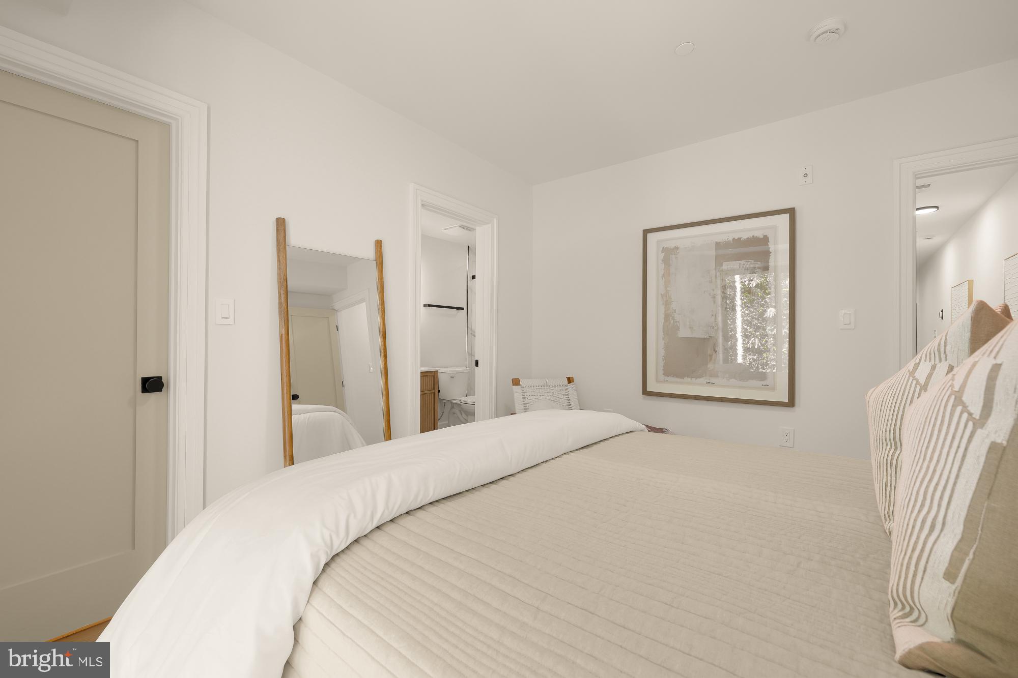 1463 Harvard Street Northwest, Unit 2 Washington, DC 20009 - Photo 21 of 25 a bedroom with a bed and a painting on the wall