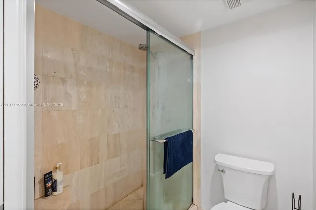 a bathroom with a shower and a toilet