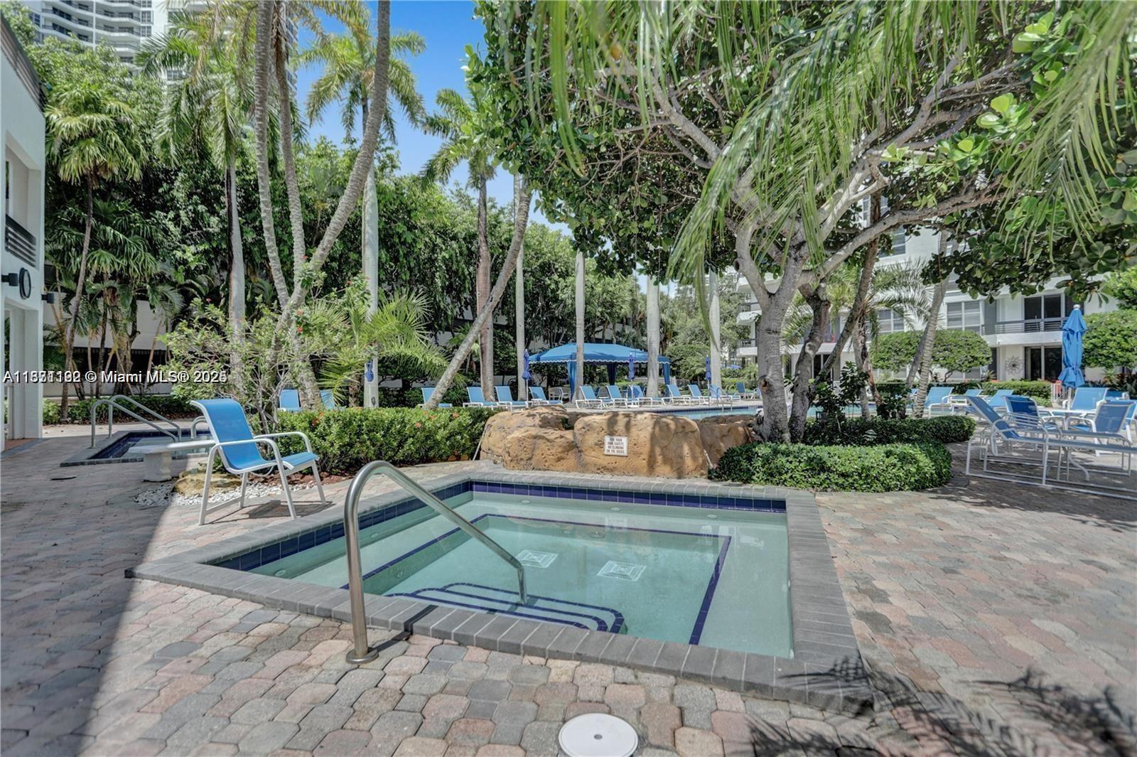 3600 Mystic Pointe Drive, Unit 215 Aventura, FL 33180 - Photo 38 of 49 a view of a backyard with sitting area