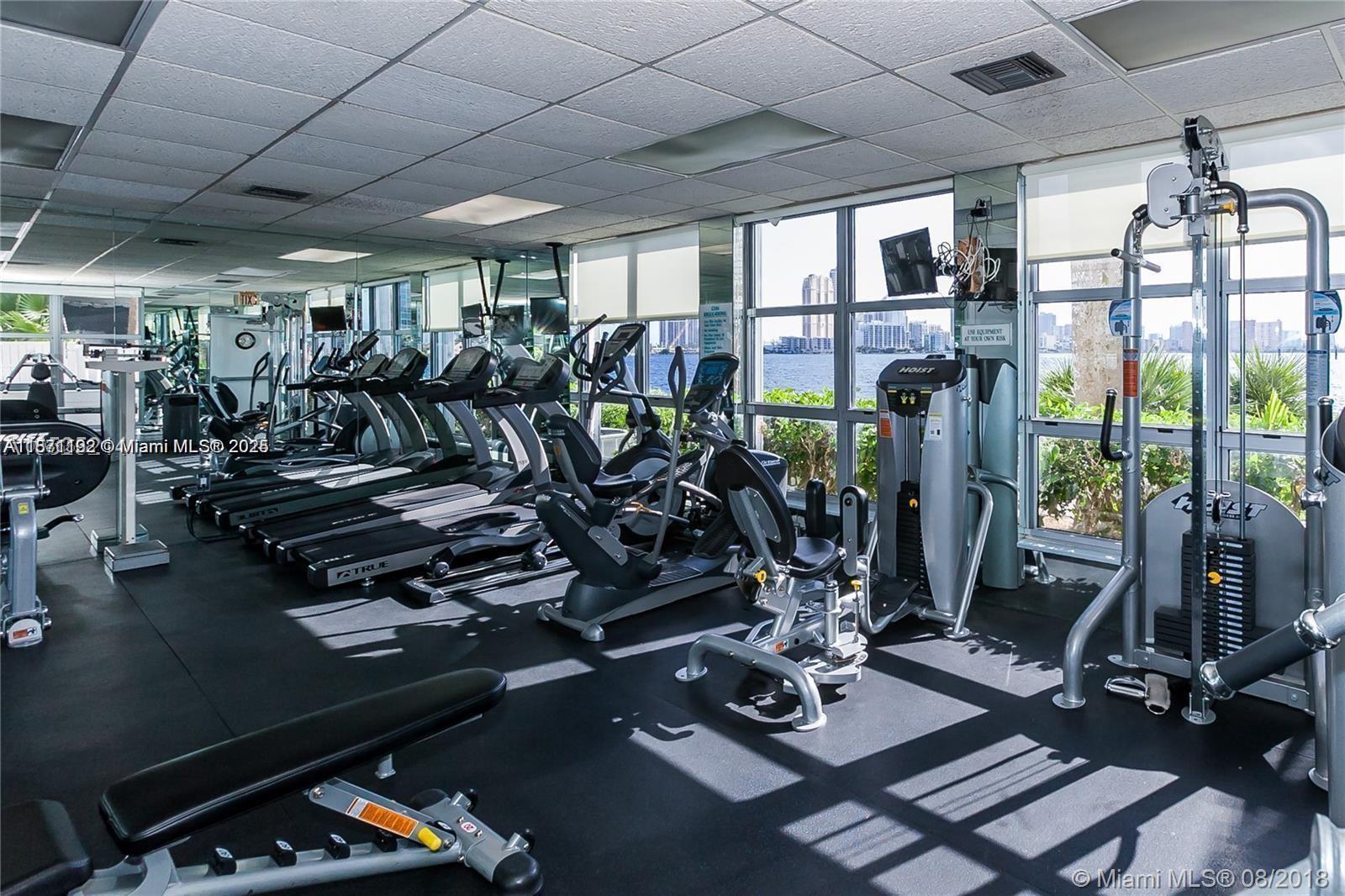 3600 Mystic Pointe Drive, Unit 215 Aventura, FL 33180 - Photo 46 of 49 a view of a room with gym equipment