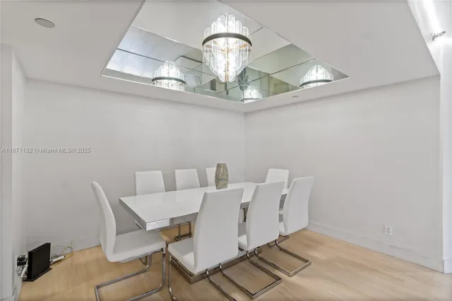 a view of a dining room with a table and chairs