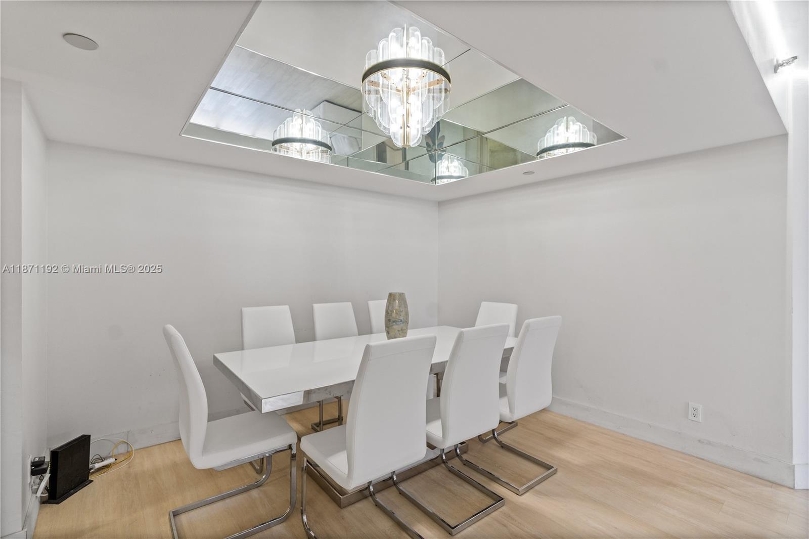 3600 Mystic Pointe Drive, Unit 215 Aventura, FL 33180 - Photo 8 of 49 a view of a dining room with a table and chairs